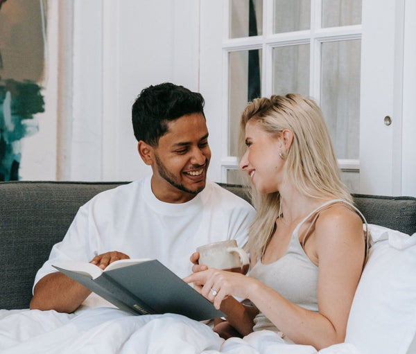 Couple reading together in bed in the morning